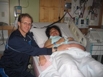 Jesse and Jin. This is after the epidural block. Notice the watch for timing contractions. The strap around Jin's stomach is for monitoring contractions.