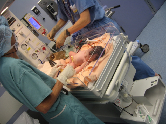 Being worked over by the pediatrician and OR nurse.