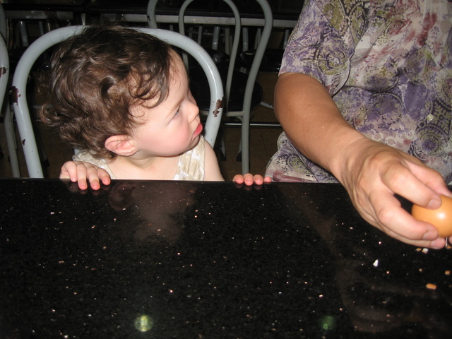 Haley watching Albert eat an egg